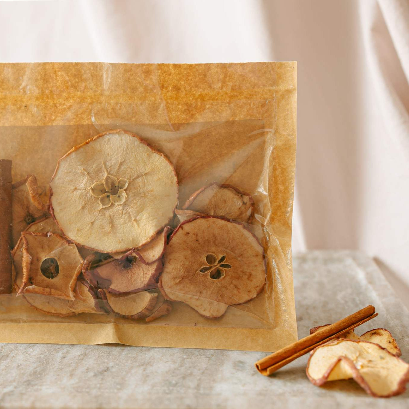 Bag of dried fruits and spices on a light fabric background
