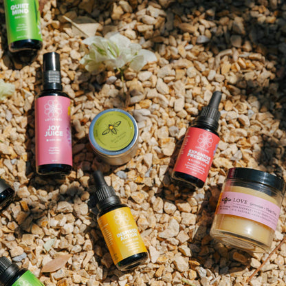 Various flower essences on a textured surface with flowers