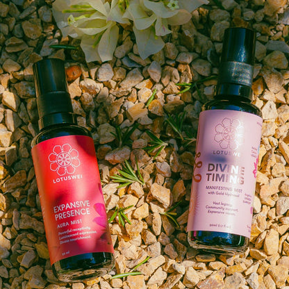 Two flower essence bottles on a stone surface with flowers