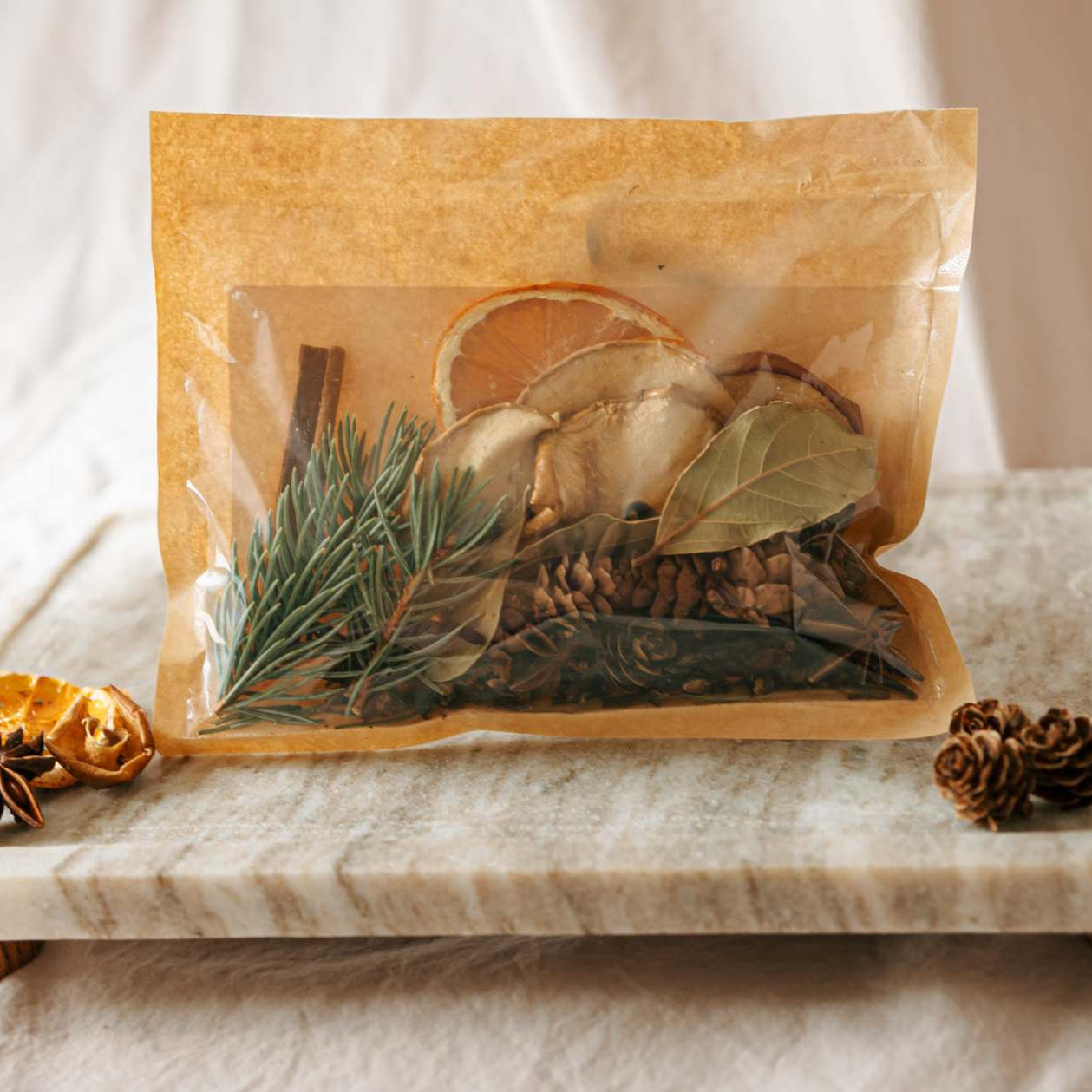 Herbal tea package with dried herbs on a marble tray