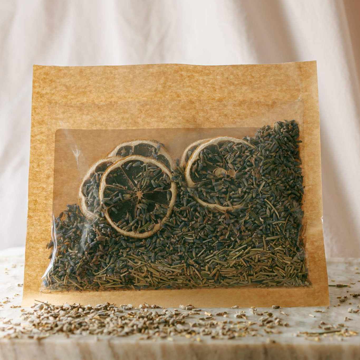 herbs in a clear plastic bag on a light fabric background