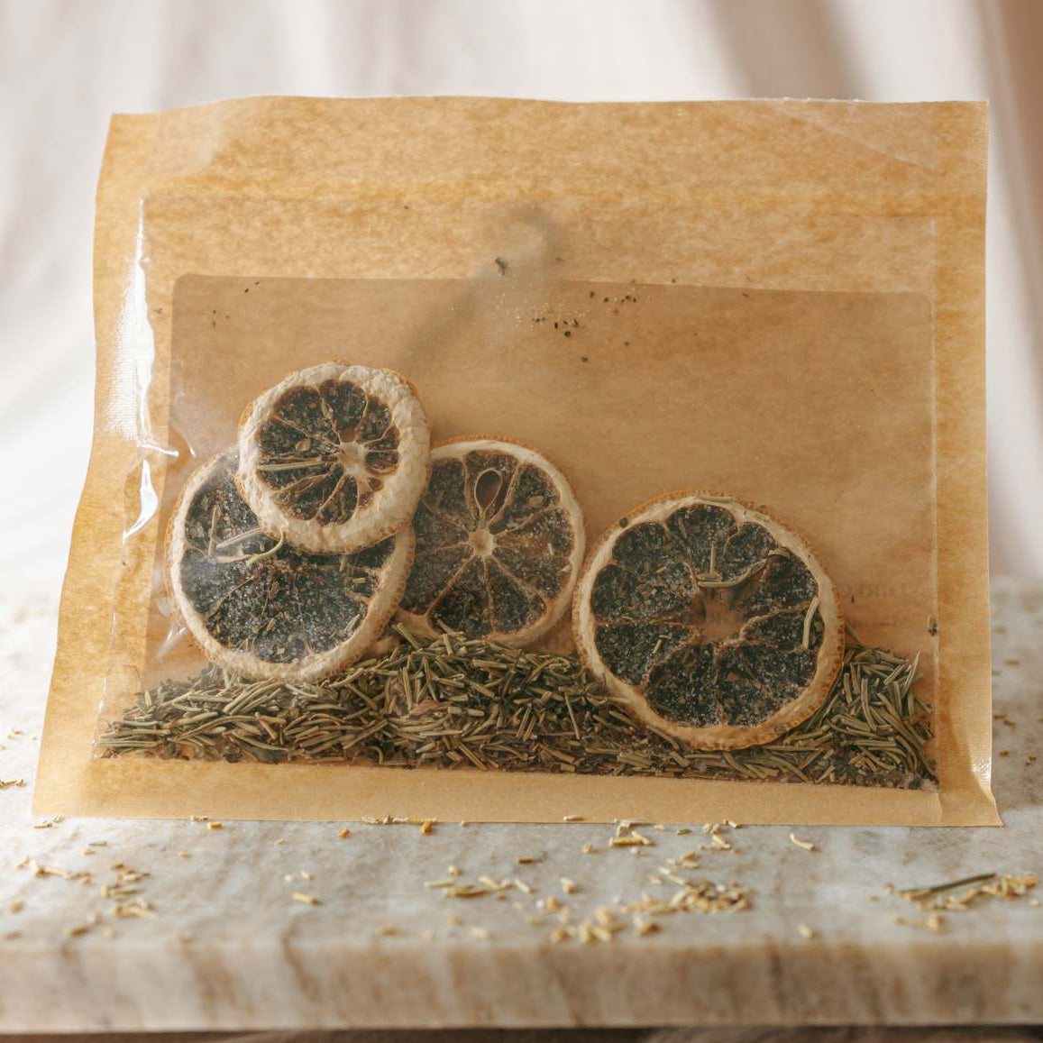 Simmer bag with dried oranges and herbs on a marble surface