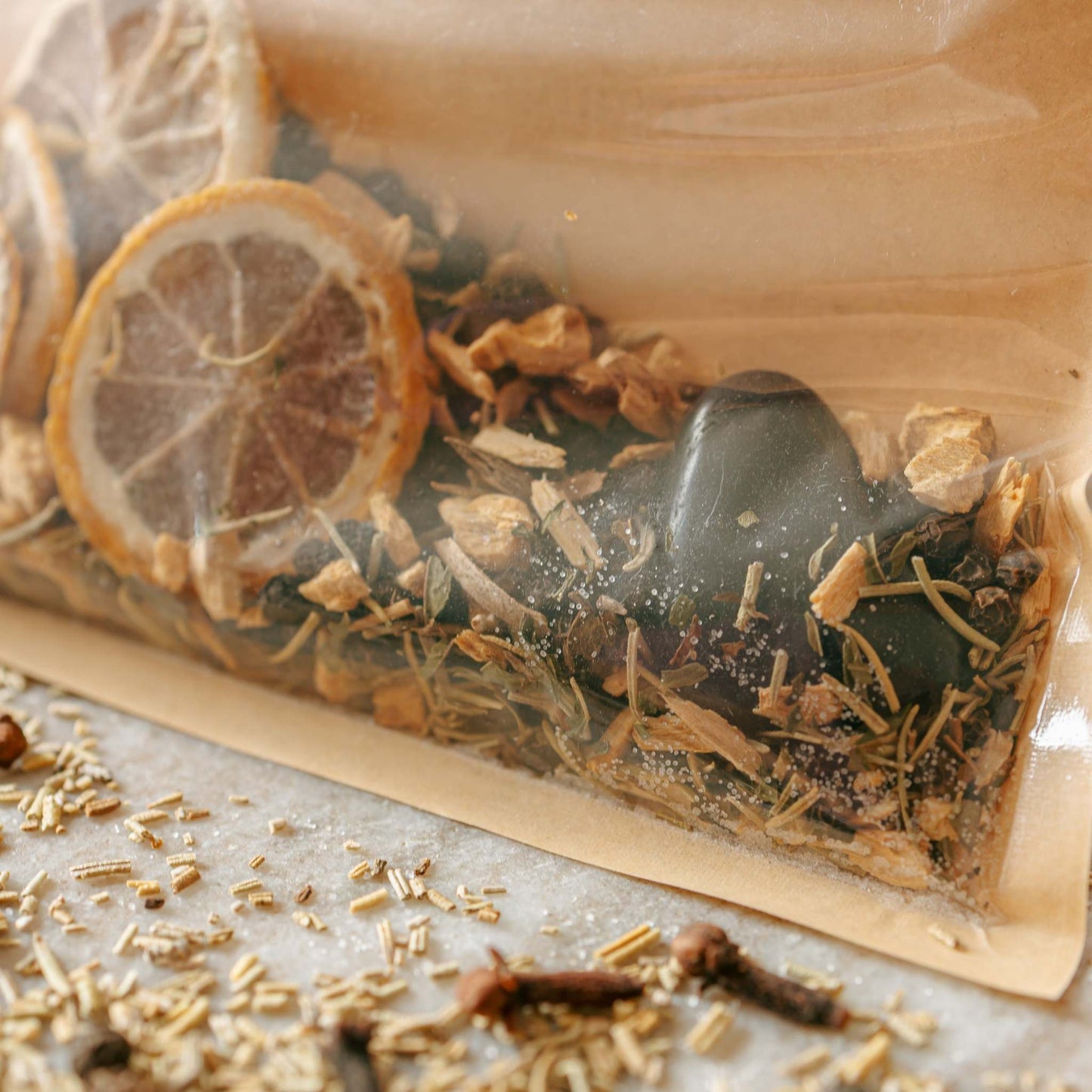 simmer kits with dried herbs and citrus slices on a light surface