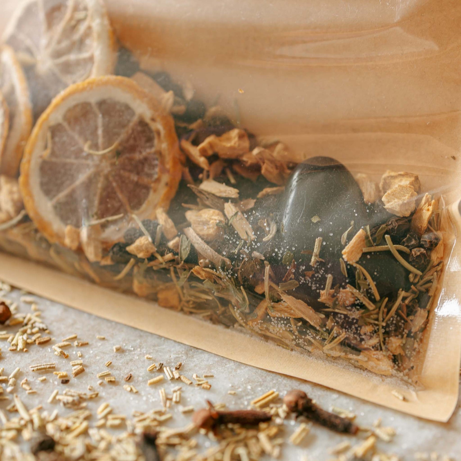 simmer kits with dried herbs and citrus slices on a light surface