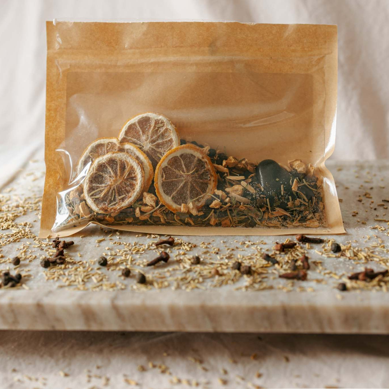 packaging with dried herbs on a marble surface