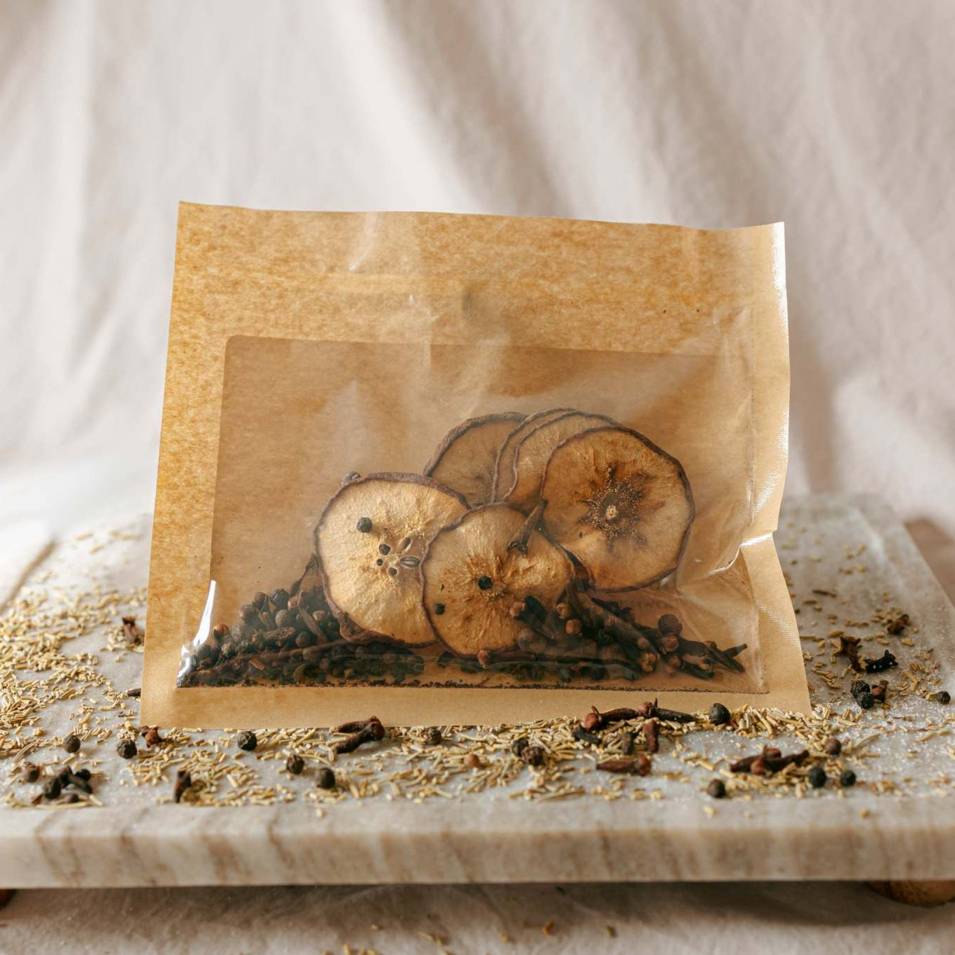 Simmer Kit packaging with dried fruits on a marble tray